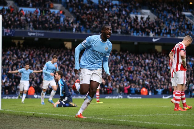 MANCHESTER, ENGLAND - FEBRUARY 22:  Yaya Toure of Manchester City runs away to celebrate after scoring the winning goal during the Barclays Premier League match between Manchester City and Stoke City at the Etihad Stadium on February 22, 2014 in Manchester, England.  (Photo by Clive Brunskill/Getty Images)