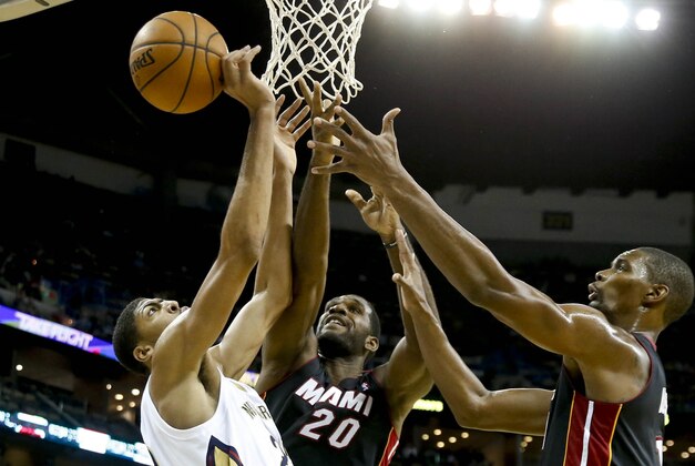 Oct 23, 2013; New Orleans, LA, USA; New Orleans Pelicans power forward Anthony Davis (23) battles for a rebound with Miami Heat center Greg Oden (20) and power forward Chris Bosh (1) during the first half of a preseason game at New Orleans Arena. Mandatory Credit: Derick E. Hingle-USA TODAY Sports