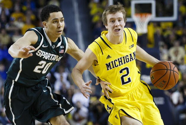 Feb 23, 2014; Ann Arbor, MI, USA; Michigan Wolverines guard Spike Albrecht (2) moves the ball defended by Michigan State Spartans guard Travis Trice (20) in the first half at Crisler Arena. Mandatory Credit: Rick Osentoski-USA TODAY Sports