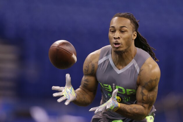 Louisville defensive back Calvin Pryor runs a drill at the NFL football scouting combine in Indianapolis, Tuesday, Feb. 25, 2014. (AP Photo/Michael Conroy)