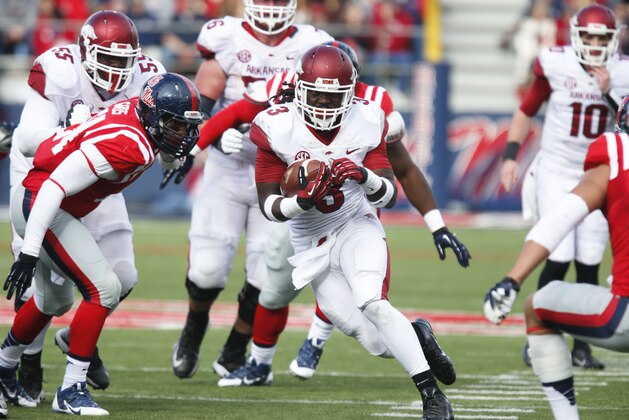 Arkansas running back Alex Collins (3) runs upfield for short yards against Mississippi during the second half of their NCAA college football game at Vaught-Hemingway Stadium in Oxford, Miss., on Saturday, Nov. 9, 2013. Mississippi won 34-24. (AP Photo/Rogelio V. Solis)