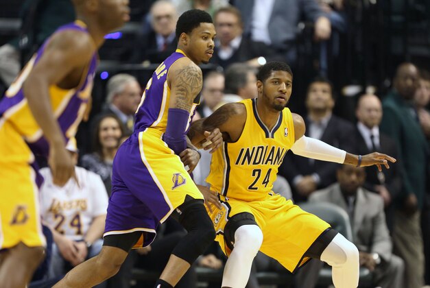 Feb 25, 2014; Indianapolis, IN, USA; Los Angeles Lakers guard Kent Bazemore (6) guards Indiana Pacers forward Paul George (24) at Bankers Life Fieldhouse. Mandatory Credit: Brian Spurlock-USA TODAY Sports