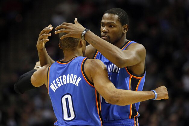 Dec 21, 2013; San Antonio, TX, USA; Oklahoma City Thunder guard Russell Westbrook (0) celebrates a score with forward Kevin Durant (3right) during the second half against the San Antonio Spurs at AT&T Center. The Thunder won 113-100. Mandatory Credit: Soobum Im-USA TODAY Sports Dec 21, 2013; San Antonio, TX, USA; Oklahoma City Thunder guard Russell Westbrook (0) celebrates a score with forward Kevin Durant (3right) during the second half against the San Antonio Spurs at AT&T Center. The Thunder won 113-100. Mandatory Credit: Soobum Im-USA TODAY Sports