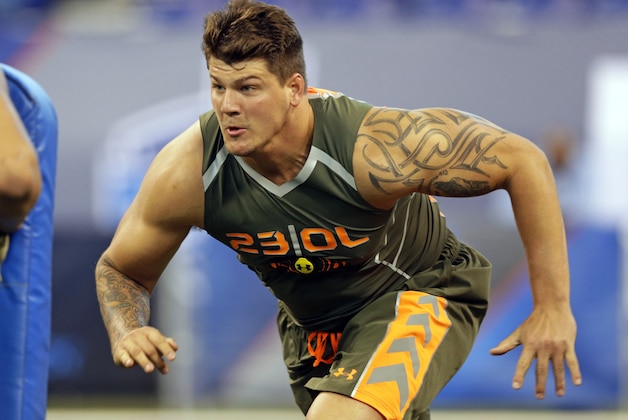 Michigan offensive lineman Taylor Lewan runs a drill at the NFL football scouting combine in Indianapolis, Saturday, Feb. 22, 2014. (AP Photo/Michael Conroy)