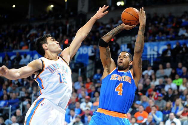 Feb 9, 2014; Oklahoma City, OK, USA; New York Knicks power forward Jeremy Tyler (4) shoots the ball over Oklahoma City Thunder center Steven Adams (12) during the second quarter at Chesapeake Energy Arena. Mandatory Credit: Mark D. Smith-USA TODAY Sports