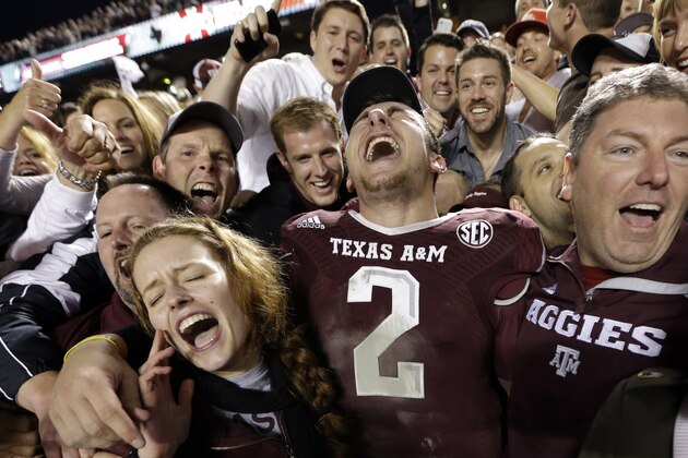 Texas A&M quarterback Johnny Manziel (2) celebrates with fans after an NCAA college football game against Mississippi State Saturday, Nov. 9, 2013, in College Station, Texas. Texas A&M won 51-41. (AP Photo/David J. Phillip)