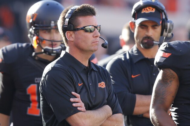 Oklahoma State head coach Mike Gundy watches from the sidelines during the first quarter of an NCAA college football game against Kansas in Stillwater, Okla., Saturday, Nov. 9, 2013. (AP Photo/Sue Ogrocki)