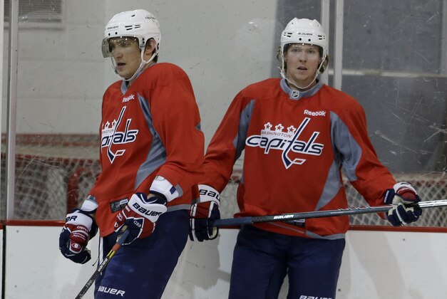 Washington Capitals captain Alex Ovechkin, left, and center Nicklas Backstrom pause during a Capitals hockey practice, Tuesday, Feb. 25, 2014, at Kettler Capitals Iceplex in Arlington, Va. Ovechkin's father had heart surgery, and Backstrom missed the gold medal game because of a failed doping test. Both players are back from an eventful Olympics. (AP Photo/Carolyn Kaster) Washington Capitals captain Alex Ovechkin, left, and center Nicklas Backstrom pause during a Capitals hockey practice, Tuesday, Feb. 25, 2014, at Kettler Capitals Iceplex in Arlington, Va. Ovechkin's father had heart surgery, and Backstrom missed the gold medal game because of a failed doping test. Both players are back from an eventful Olympics. (AP Photo/Carolyn Kaster)