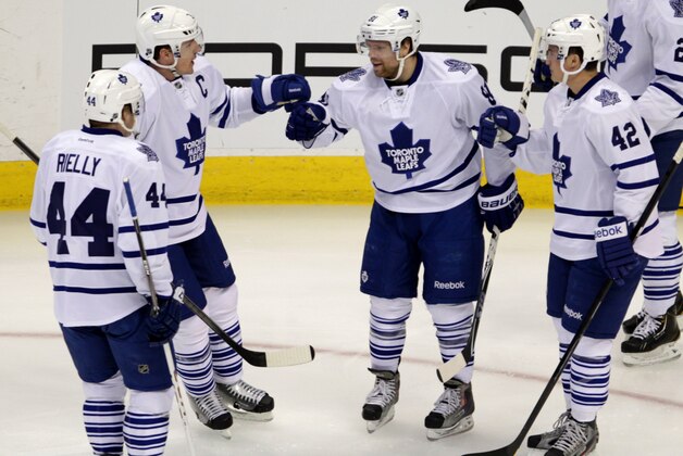 Toronto Maple Leafs defenseman Morgan Rielly (44), Maple Leafs defenseman Dion Phaneuf (3) and Maple Leafs center Tyler Bozak (42) congratulate Maple Leafs right wing Phil Kessel (81) for his goal against the Colorado Avalanche during the second period of an NHL game in Denver on Tuesday, Jan. 21, 2014.(AP Photo/Joe Mahoney)