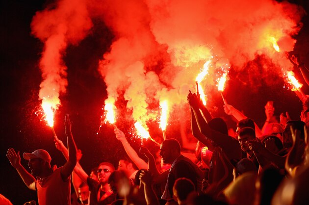 NOTTINGHAM, ENGLAND - JULY 16:  Galatasaray fans light flares during the pre season friendly match between Notts County and Galatasaray at Meadow Lane on July 16, 2013 in Nottingham, England.  (Photo by Clive Mason/Getty Images)