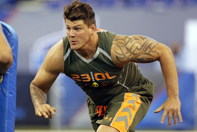 Michigan offensive lineman Taylor Lewan runs a drill at the NFL football scouting combine in Indianapolis, Saturday, Feb. 22, 2014. (AP Photo/Michael Conroy)