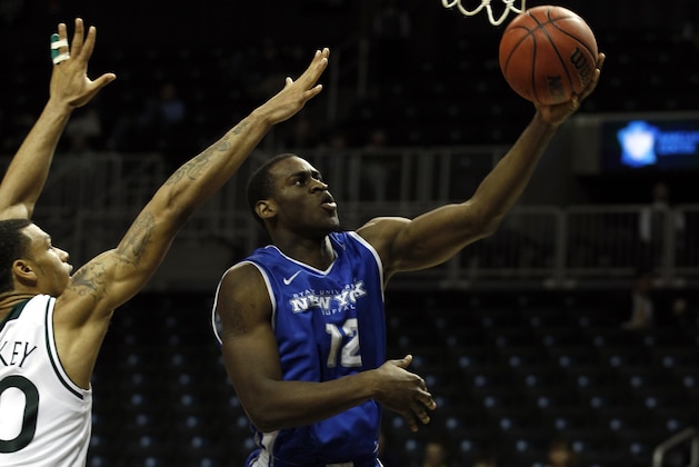 NEW YORK, NY - DECEMBER 21:  Javon McCrea #12 of the Buffalo Bulls drives to the basket past Ashton Pankey #30 of the Manhattan Jaspers during the Brooklyn Hoops Holiday Invitational at Barclays Center on December 21, 2013 in the Brooklyn borough of New York City.  (Photo by Adam Hunger/Getty Images)