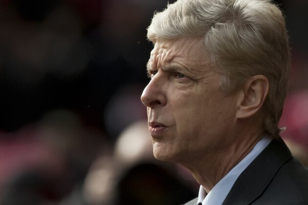 Arsenal's manager Arsene Wenger takes to the touchline before his team's English Premier League soccer match against Liverpool at Anfield Stadium, Liverpool, England, Saturday Feb. 8, 2014. (AP Photo/Jon Super)