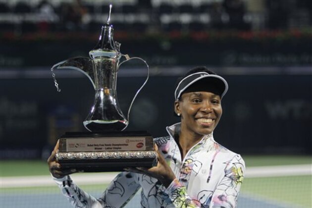 Venus Williams of the U.S. holds the trophy after she beat Alize Cornet of France during the final match of Dubai Duty Free Tennis Championships in Dubai, United Arab Emirates, Saturday, Feb. 22, 2014. (AP Photo/Kamran Jebreili)