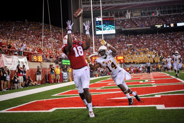 LINCOLN, NE - AUGUST 31: Wide receiver Quincy Enunwa #18 of the Nebraska Cornhuskers catches a touchdown over cornerback Tyran Finley #14 of the Wyoming Cowboys during their game at Memorial Stadium on August 31, 2013 in Lincoln, Nebraska. Nebraska defeated Wyoming 37-34. (Photo by Eric Francis/Getty Images)