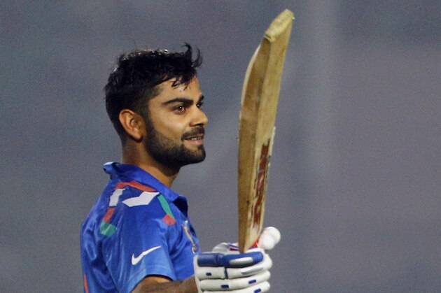 India’s Virat Kohli acknowledges the crowd after scoring a century during the Asia Cup one-day international cricket tournament against Bangladesh in Fatullah, near Dhaka, Bangladesh, Wednesday, Feb. 26, 2014. (AP Photo/A.M. Ahad)