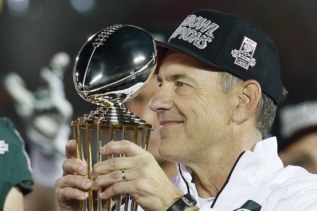 Michigan State head coach Mark Dantonio holds the trophy after the Rose Bowl NCAA college football game between Stanford and Michigan State, on Wednesday, Jan. 1, 2014, in Pasadena, Calif. (AP Photo/Danny Moloshok)