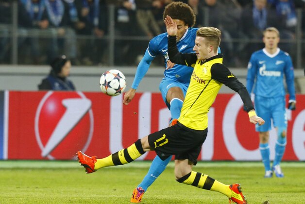 Borussia's Marco Reus blocks Zenit's Axel Witsel, right, from making a kick during the Champions League soccer match between Zenit St.Petersburg and  Borussia Dortmund at Petrovsky stadium in St.Petersburg, Russia, on Tuesday, Feb. 25, 2014. (AP Photo/Dmitry Lovetsky)