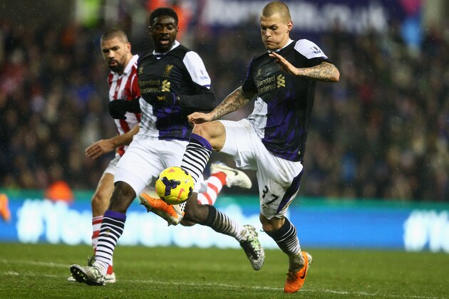 STOKE ON TRENT, ENGLAND - JANUARY 12:  Martin Skrtel of Liverpool is watched by team mate Kolo Toure of Liverpool during the Barclays Premier League match between Stoke City and Liverpool at Britannia Stadium on January 12, 2014 in Stoke on Trent, England.  (Photo by Clive Mason/Getty Images)