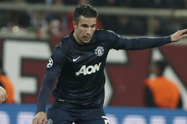 Manchester United's Robin Van Persie runs with the ball  during a Champions League, round of 16, first leg soccer match against  Olympiakos at Georgios Karaiskakis stadium, in Piraeus port, near Athens, on Tuesday, Feb. 25, 2014. (AP Photo/Petros Giannakouris)