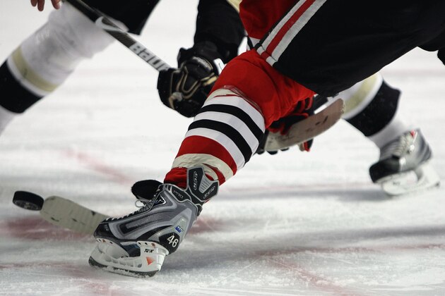 CHICAGO - FEBRUARY 27: Colin Fraser #46 of the Chicago Blackhawks battles a member of the Pittsburgh Penguins during a face-off on February 27, 2009 at the United Center in Chicago, Illinois. The Penguins defeated the Blackhawks 5-4 in overtime. (Photo by Jonathan Daniel/Getty Images)
