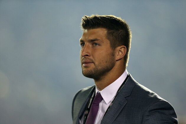 PASADENA, CA - JANUARY 06:  ESPN analyst Tim Tebow looks on during the 2014 Vizio BCS National Championship Game between the Florida State Seminoles and the Auburn Tigers at the Rose Bowl on January 6, 2014 in Pasadena, California.  (Photo by Jeff Gross/Getty Images)