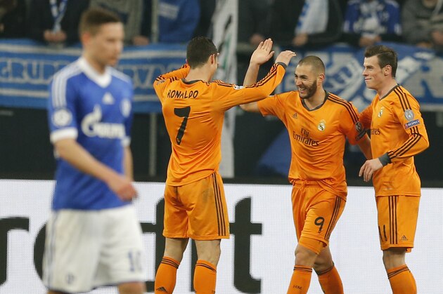 Real's Cristiano Ronaldo, Real's Karim Benzema and Real's Gareth Bale, from left, celebrate their team's fourth goal during the Champions League round of the last 16 first leg soccer match between Schalke 04 and Real Madrid in Gelsenkirchen, Germany, Wednesday, Feb.26,2014. (AP Photo/Frank Augstein)