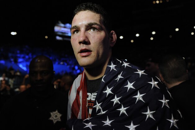 Chris Weidman, of Baldwin, N.Y., walks after defeating Anderson Silva, of Brazil, during the UFC 168 mixed martial arts middleweight championship bout on Saturday, Dec. 28, 2013, in Las Vegas. Weidman won during the second round by a technical knockout after Silva was injured. (AP Photo/David Becker)