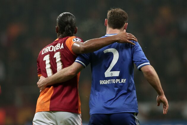Former Chelsea star, Didier Drogba of Galatasaray, left, and Branislav Ivanovic of Chelsea during their Champions League Round of 16, First Leg match between Galatasaray and Chelsea at Turk Telekom Arena Stadium in Istanbul, Turkey, Wednesday, Feb. 26, 2014. (AP Photo/Emrah Gurel)