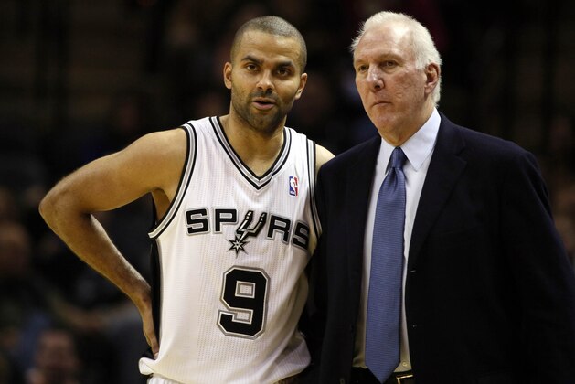 Dec 23, 2013; San Antonio, TX, USA; San Antonio Spurs guard Tony Parker (9) talks with head coach Gregg Popovich during the second half against the Toronto Raptors at AT&T Center. The Spurs won 112-99. Mandatory Credit: Soobum Im-USA TODAY Sports