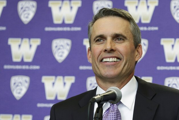 Chris Petersen smiles as he takes questions from reporters after being introduced as the new head football coach at the University of Washington, Monday, Dec. 9, 2013, in Seattle. Petersen formerly was head coach at Boise State. (AP Photo/Ted S. Warren)