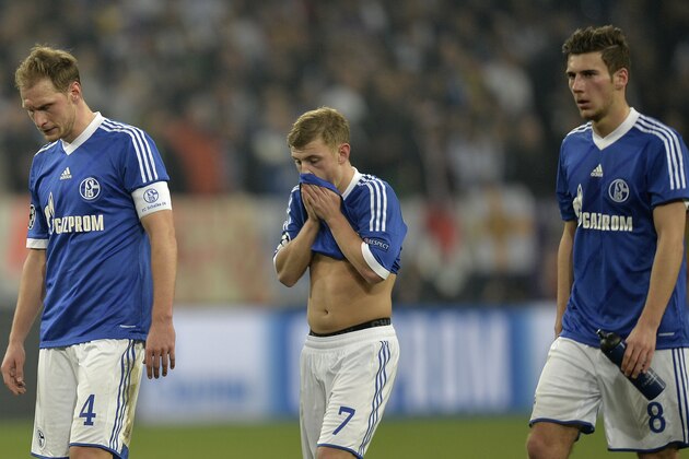 Schalke's Benedikt Hoewedes, left,  Max Meyer, centre and Leon Goretzka leave the field at the end of a Champions League round of sixteen, first leg soccer match between Schalke 04 and Real Madrid at the Veltins Arena in Gelsenkirchen, Germany, Wednesday Feb. 26, 2014. Schalke lost the match 6-1. (AP Photo/Martin Meissner)