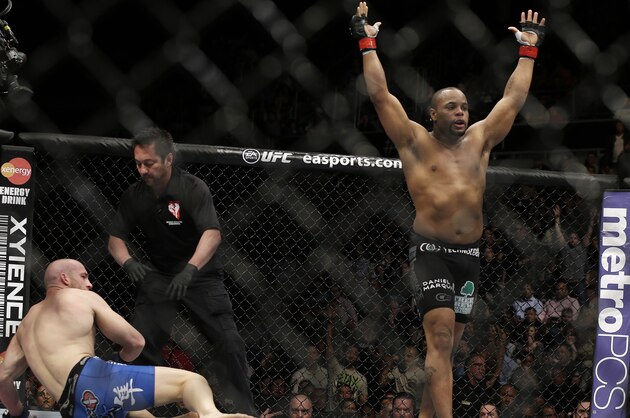 Daniel Cormier, right, reacts as the referee stops his UFC 170 mixed martial arts light heavyweight fight against Patrick Cummins on Saturday, Feb. 22, 2014, in Las Vegas. (AP Photo/Isaac Brekken)