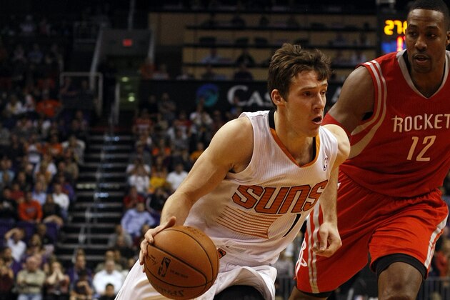 Phoenix Suns shooting guard Goran Dragic (1) drives on Houston Rockets center Dwight Howard (12) in the second quarter during an NBA basketball game, Sunday, Feb. 23, 2014, in Phoenix. (Rick Scuteri/AP Images)