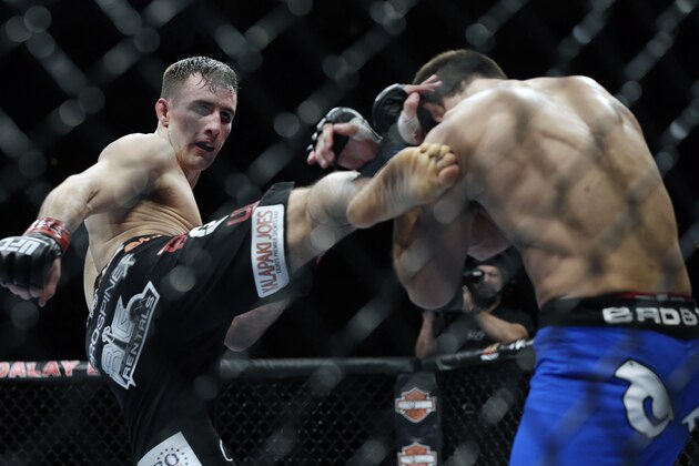 Rory MacDonald, left, kicks Demian Maia during a UFC 170 mixed martial arts welterweight fight on Saturday, Feb. 22, 2014, in Las Vegas. MacDonald won by unanimous decision. (AP Photo/Isaac Brekken)