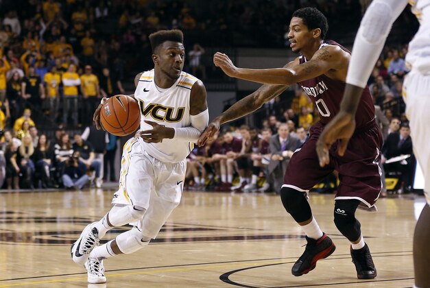Jan 29, 2014; Richmond, VA, USA; Virginia Commonwealth Rams guard JeQuan Lewis (1) dribbles the ball as Fordham Rams guard Branden Frazier (0) defends in the second half at Stuart C. Siegel Center. The Rams won 76-60. Mandatory Credit: Geoff Burke-USA TODAY Sports