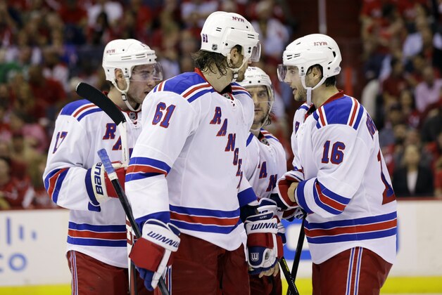 New York Rangers defenseman John Moore (17), left wing Rick Nash (61), right wing Mats Zuccarello (36), from Norway, and center Derick Brassard (16) talk in the third period of Game 5 first-round NHL Stanley Cup playoff hockey series against the Washington Capitals, Friday, May 10, 2013 in Washington. (AP Photo/Alex Brandon)