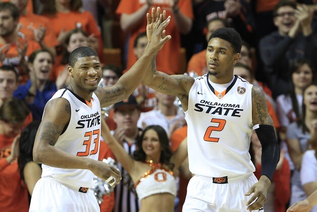 Feb 22, 2014; Stillwater, OK, USA; Oklahoma State Cowboys guard Marcus Smart (33) and wing Le'Bryan Nash celebrate after a basket against Texas Tech Red Raiders during the first half  at Gallagher-Iba Arena. Oklahoma State Cowboys won 84-62. Mandatory Credit: Alonzo Adams-USA TODAY Sports