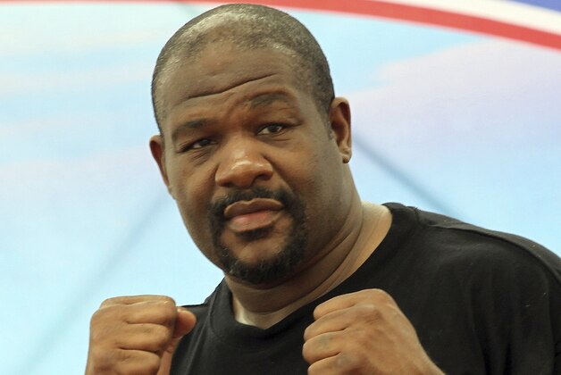 In this photo taken May 24, 2014, former world heavyweight boxing champion Riddick Bowe poses while holding a boxing clinic to Thai vocational students in Lopburi province, central Thailand. For years, Riddick Bowe dreamed of getting back into the ring - just not this ring and this sport, in this country. Next week in Thailand,  the former world heavyweight boxing champion the world will step out of retirement to make his debut as a Muay Thai fighter - the brutal martial art that makes boxing look gentlemanly. (AP Photo/Apichart Weerawong)