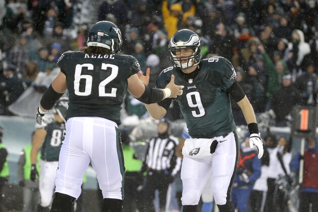 Philadelphia Eagles' Nick Foles, right, and Jason Kelce celebrate after a two-point conversion during the second half of an NFL football game, Sunday, Dec. 8, 2013, in Philadelphia. (AP Photo/Matt Rourke)