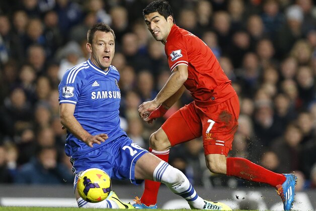Chelsea's John Terry, left, vies for the ball with Liverpool's Luis Suarez during the English Premier League soccer match between Chelsea and Liverpool at Stamford Bridge Stadium in London, Sunday, Dec. 29, 2013. (AP Photo/Kirsty Wigglesworth)