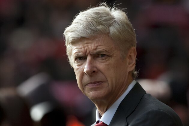 Arsenal's manager Arsene Wenger takes to the touchline before his team's English Premier League soccer match against Liverpool at Anfield Stadium, Liverpool, England, Saturday Feb. 8, 2014. (AP Photo/Jon Super)