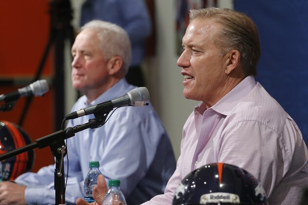 Denver Broncos Vice President John Elway, right, speaks during an end of the season news conference at the NFL football team's headquarters in Englewood, Colo., on Tuesday, Feb. 4, 2014. Head coach John Fox listens at left. (AP Photo/Ed Andrieski)