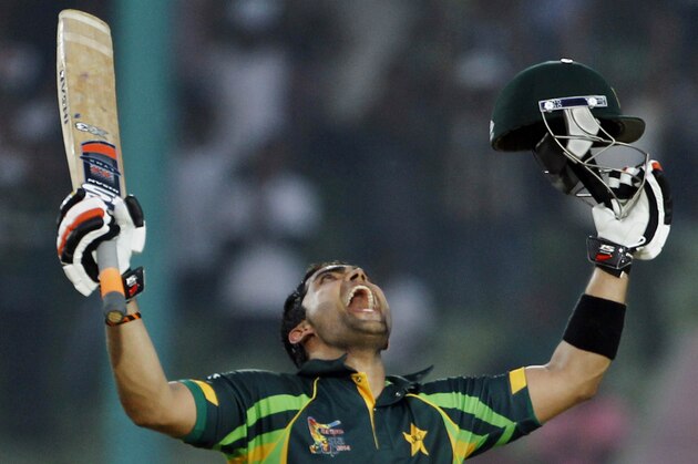 Pakistan’s Umar Akmal celebrates after scoring a century during the Asia Cup one-day international cricket tournament against Afghanistan in Fatullah, near Dhaka, Bangladesh, Thursday, Feb. 27, 2014. (AP Photo/A.M. Ahad)