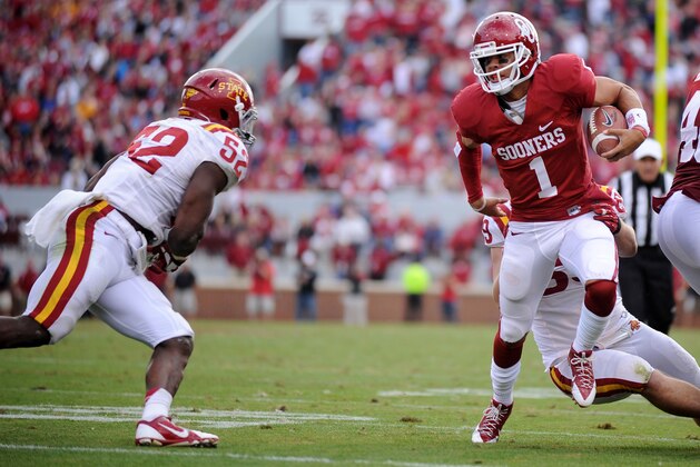 Nov 16, 2013; Norman, OK, USA; Oklahoma Sooners quarterback Kendal Thompson (1) runs the ball against Iowa State Cyclones Iowa State Cyclones linebacker Jeremiah George (52) in the second half at Gaylord Family - Oklahoma Memorial Stadium. Mandatory Credit: Mark D. Smith-USA TODAY Sports