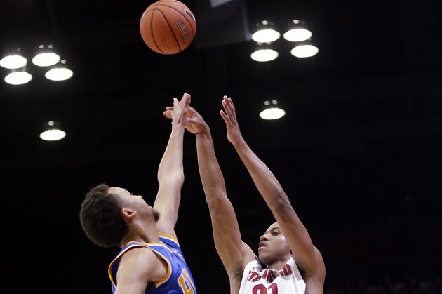 Stanford guard/forward Anthony Brown (21) shoots over UCLA guard Kyle Anderson during the second half of an NCAA college basketball game on Saturday, Feb. 22, 2014, in Stanford, Calif. Stanford won 83-74. (AP Photo/Marcio Jose Sanchez)