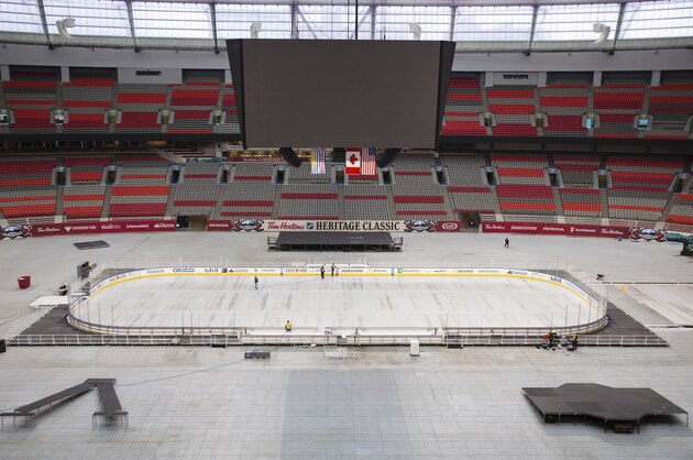 VANCOUVER, BC - FEBRUARY 26:  Workers build the rink for the 2014 Heritage Classic Game on February 26, 2014 at B.C. Place in Vancouver, B.C., Canada. The Ottawa Senators and the Vancouver Canucks square off in this year's annual classic.  (Photo by Kevin Light/NHLI via Getty Images)