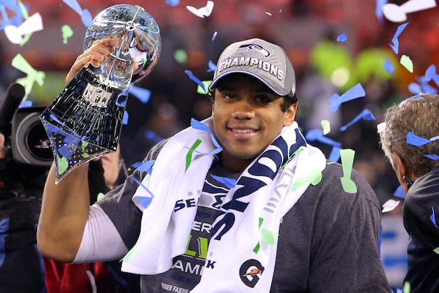 Feb 2, 2014; East Rutherford, NJ, USA; Seattle Seahawks quarterback Russell Wilson (3) celebrates with the Lombardi Trophy after beating the Denver Broncos 43-8 in Super Bowl XLVIII at MetLife Stadium.  Mandatory Credit: Brad Penner-USA TODAY Sports
