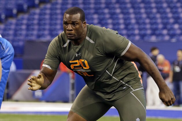 Alabama offensive lineman Cyrus Kouandjio runs a drill at the NFL football scouting combine in Indianapolis, Saturday, Feb. 22, 2014. (AP Photo/Michael Conroy)