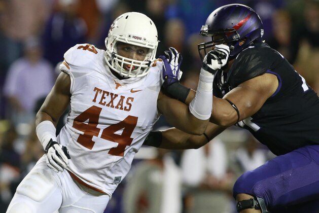 Oct 26, 2013; Fort Worth, TX, USA; Texas Longhorns defensive end Jackson Jeffcoat (44) rushes the passer against TCU Horned Frogs offensive tackle Halapoulivaati Vaitai (74) in the third quarter of the game at Amon G. Carter Stadium. Mandatory Credit: Tim Heitman-USA TODAY Sports